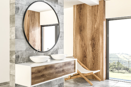 Custom mirror and natural wood tones in luxury bathroom