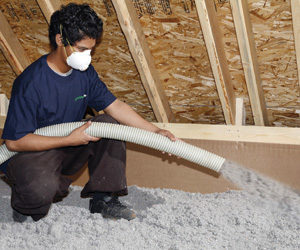 Worker installing insulation