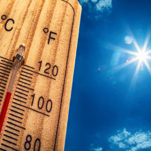 Closeup of a thermometer on a hot sunny day.