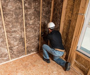 Worker installing insulation