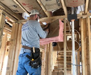 Worker installing insulation