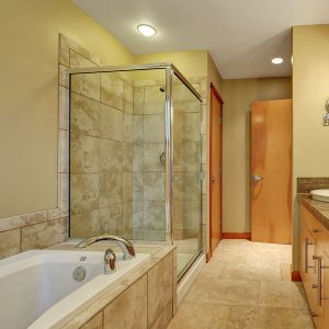 Framed shower door in a modern bathroom.