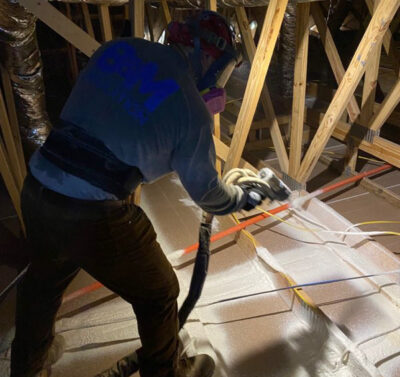 Worker sealing attic for energy-efficient insulation Worker sealing attic for energy-efficient insulation